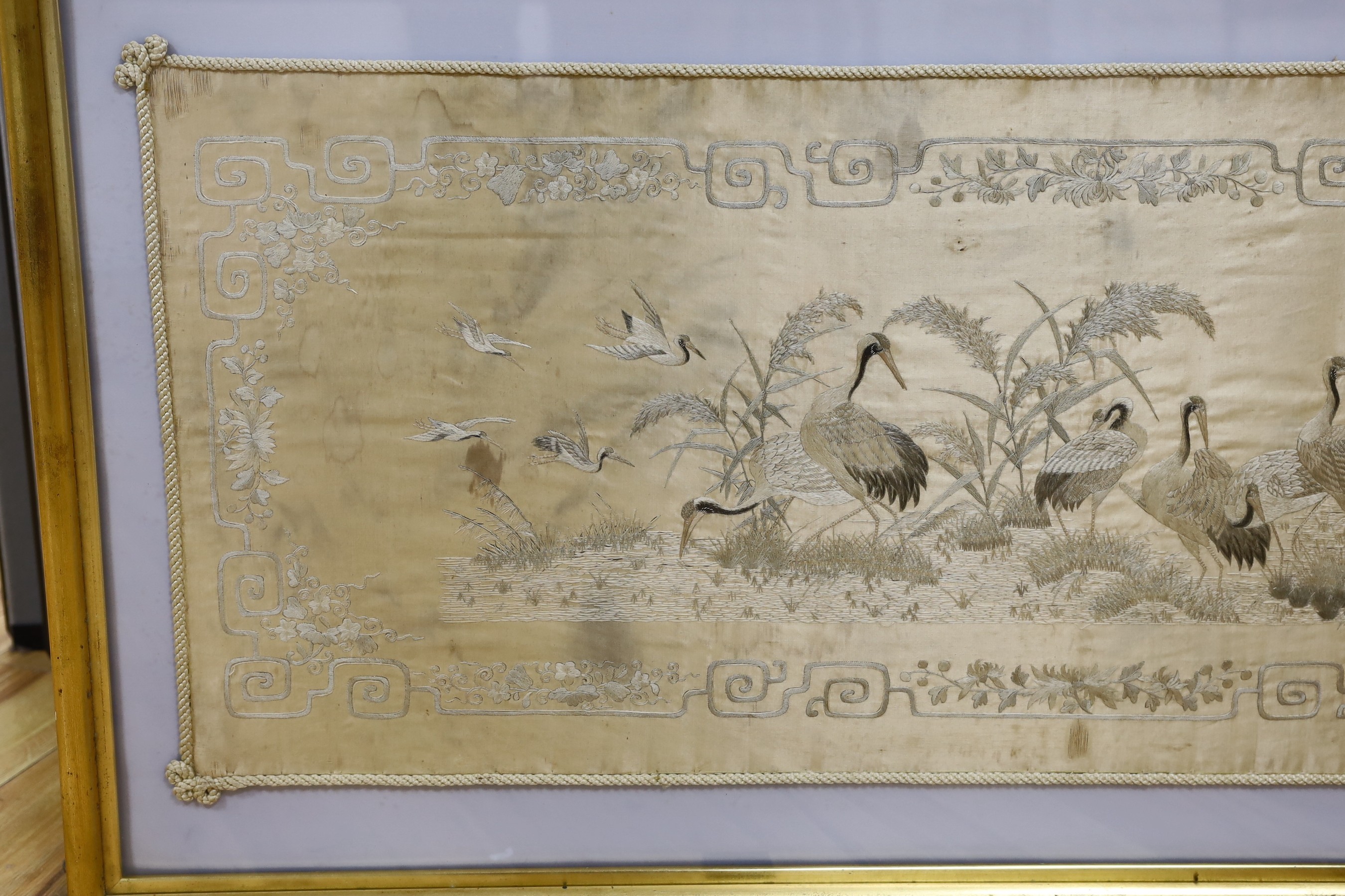 A Japanese silkwork panel, 39cm x 122cm
